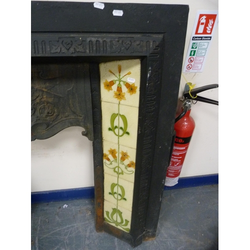 421 - Antique cast iron fire surround with tiled inserts.