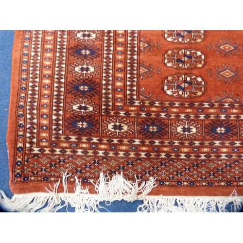 477 - Bokhara rug on red ground.