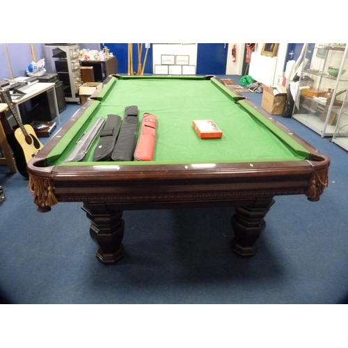 489 - American 8½ft slate bed pool table by Brunswick, with cues in cue holder and four other cased cues t... 