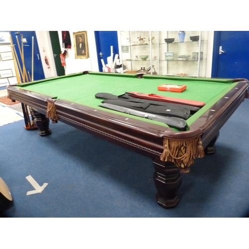 489 - American 8½ft slate bed pool table by Brunswick, with cues in cue holder and four other cased cues t... 