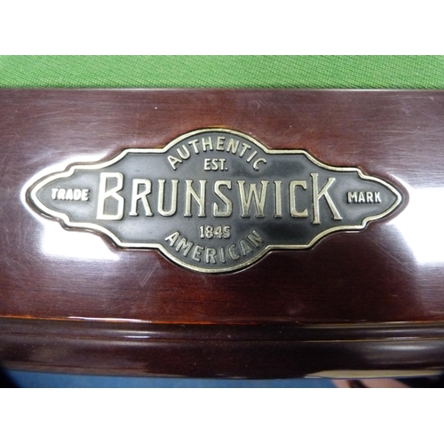 489 - American 8½ft slate bed pool table by Brunswick, with cues in cue holder and four other cased cues t... 