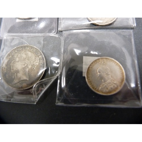 186 - Four Victorian silver coins, various denominations dated 1885, 1887, 1889 and 1890, two USA silver c... 