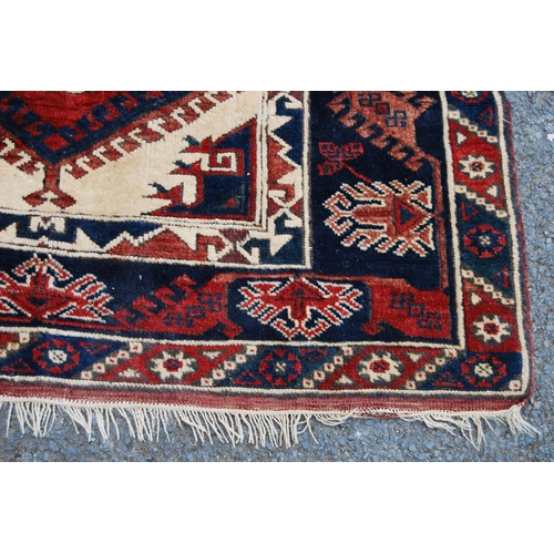 300 - Turkish hand-knotted rug with three geometric lozenges to the centre, further geometric medallions a... 