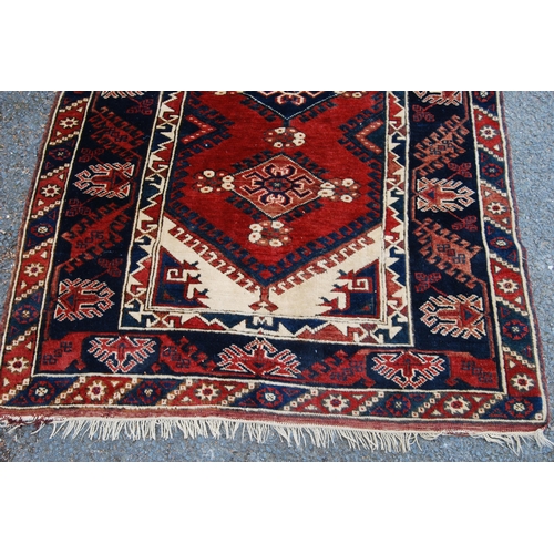 300 - Turkish hand-knotted rug with three geometric lozenges to the centre, further geometric medallions a... 