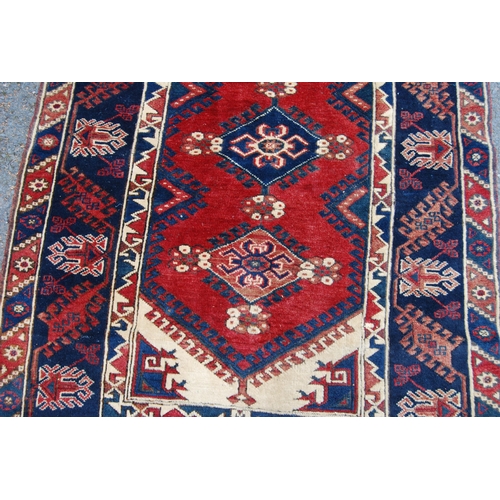 300 - Turkish hand-knotted rug with three geometric lozenges to the centre, further geometric medallions a... 