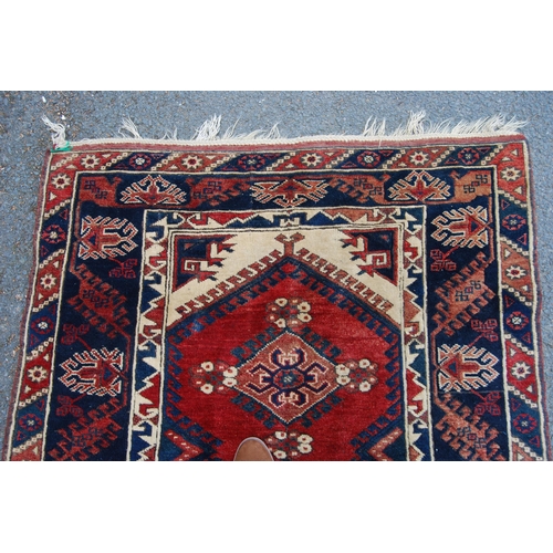 300 - Turkish hand-knotted rug with three geometric lozenges to the centre, further geometric medallions a... 