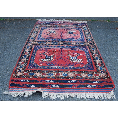 301 - Turkish Milas hand-knotted rug with two panels of nomadic animals within geometric motifs and guls, ... 