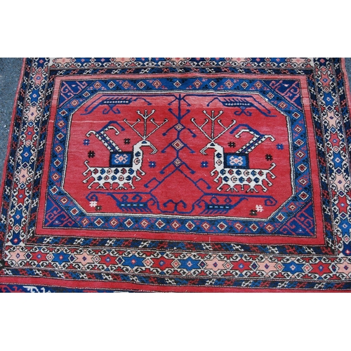 301 - Turkish Milas hand-knotted rug with two panels of nomadic animals within geometric motifs and guls, ... 