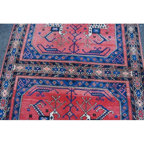 301 - Turkish Milas hand-knotted rug with two panels of nomadic animals within geometric motifs and guls, ... 