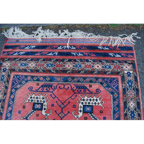 301 - Turkish Milas hand-knotted rug with two panels of nomadic animals within geometric motifs and guls, ... 