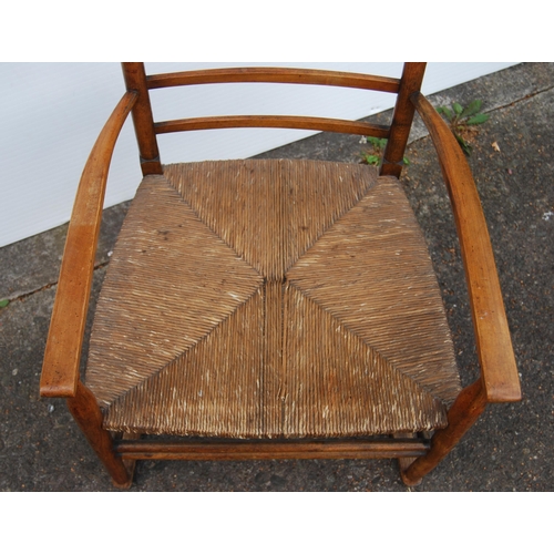 353 - In the Manner of LibertyArts and Crafts ash and elm ladder-back elbow chair with shaped armrests, wo... 