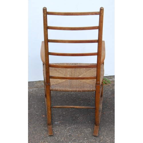 353 - In the Manner of LibertyArts and Crafts ash and elm ladder-back elbow chair with shaped armrests, wo... 