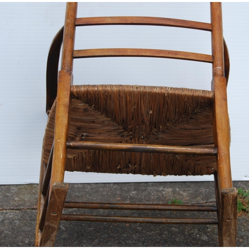 353 - In the Manner of LibertyArts and Crafts ash and elm ladder-back elbow chair with shaped armrests, wo... 