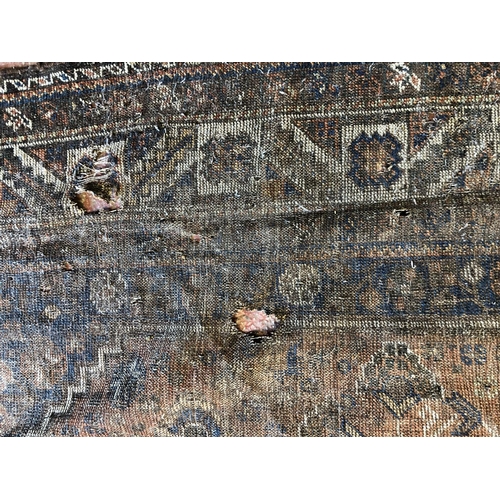 483 - Caucasian rug, with medallion on field with floral decoration and having joined spandrels, well-worn... 