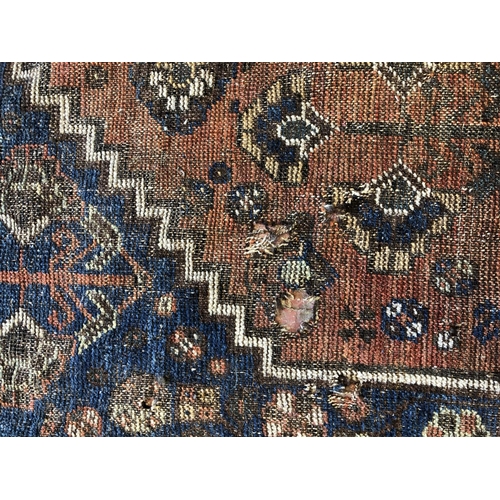 483 - Caucasian rug, with medallion on field with floral decoration and having joined spandrels, well-worn... 