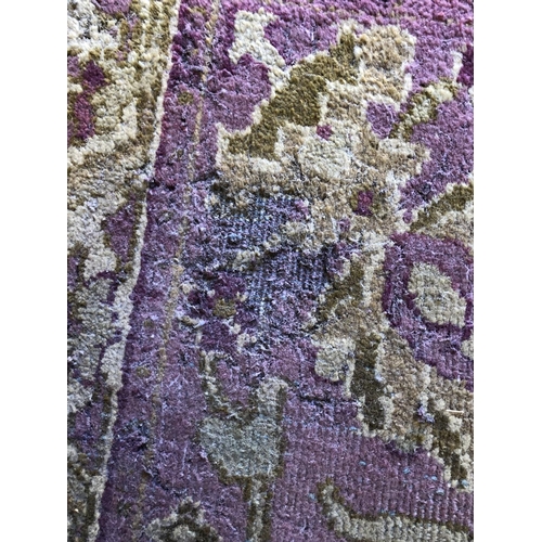 488 - Hand woven carpet in greens and purples, 345cm x 275cm.