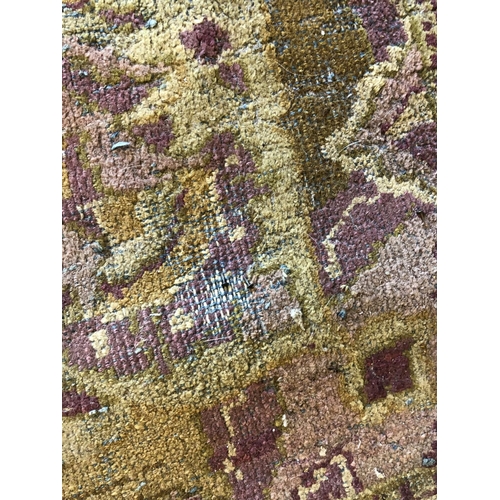 488 - Hand woven carpet in greens and purples, 345cm x 275cm.