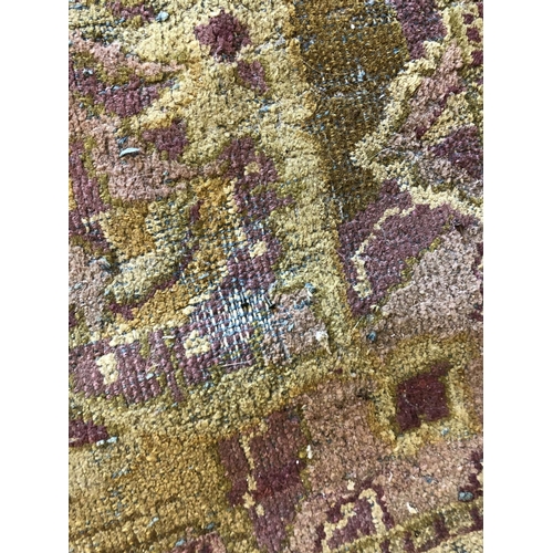 488 - Hand woven carpet in greens and purples, 345cm x 275cm.