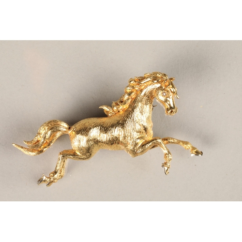 110 - Ladies 18ct yellow gold brooch in the form of a prancing horse, set with a diamond chip eye, 11g