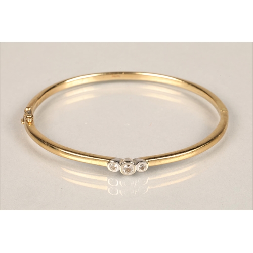 121 - Ladies 9ct yellow gold stiff bangle, set with three small diamonds, diameter 6.5cm, weight 14.3g