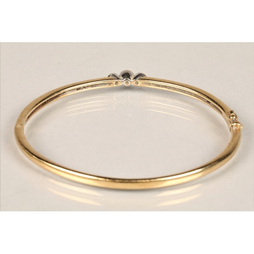 121 - Ladies 9ct yellow gold stiff bangle, set with three small diamonds, diameter 6.5cm, weight 14.3g