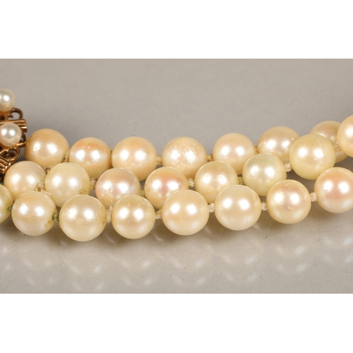 122 - Three strand pearl necklace with an ornate 9ct yellow gold, coral and seed pearl clasp, length 35.5c... 