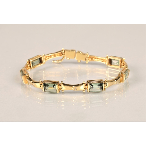 123 - Ladies 18ct yellow gold diamond and green gem stone bracelet with matching pair of earrings, length ... 