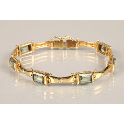 123 - Ladies 18ct yellow gold diamond and green gem stone bracelet with matching pair of earrings, length ... 