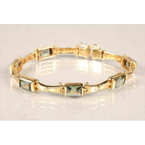 123 - Ladies 18ct yellow gold diamond and green gem stone bracelet with matching pair of earrings, length ... 