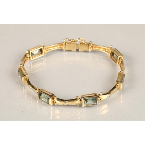 123 - Ladies 18ct yellow gold diamond and green gem stone bracelet with matching pair of earrings, length ... 