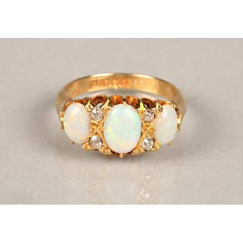 131 - Ladies 18ct yellow gold opal ring, three graduated opals interspersed with four small diamonds set o... 