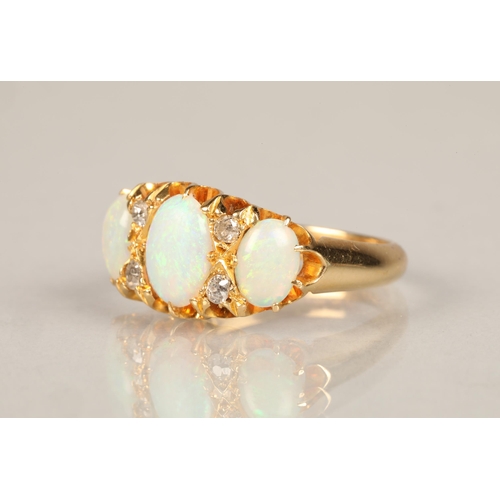 131 - Ladies 18ct yellow gold opal ring, three graduated opals interspersed with four small diamonds set o... 