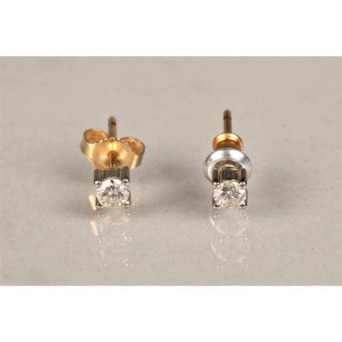 140 - Pair of diamond stud earrings, on unmarked yellow and white metal, each stone 0.1 carat