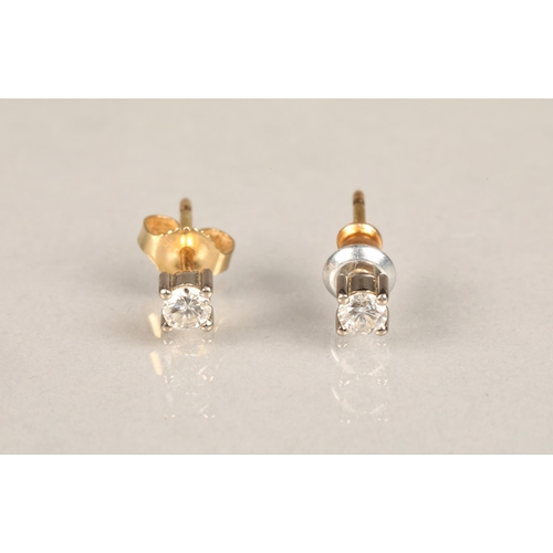 140 - Pair of diamond stud earrings, on unmarked yellow and white metal, each stone 0.1 carat