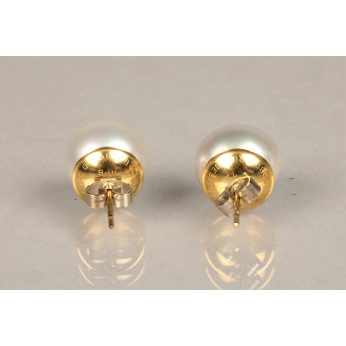 153 - Pair of 18ct yellow gold mounted pearl earrings. Probably South sea pearls, diameter 1.2cm