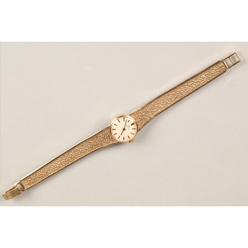 168 - Ladies 9ct yellow gold Omega wrist watch, champagne dial with hour marker batons on a textured 9ct g... 