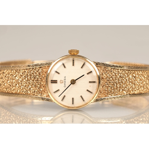 168 - Ladies 9ct yellow gold Omega wrist watch, champagne dial with hour marker batons on a textured 9ct g... 