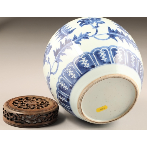 262 - 19th century Chinese blue and white ginger jar, with carved hardwood cover, the jar decorated with a... 