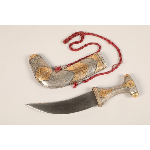 273 - A middle Eastern Omani white metal mounted Jambiya dagger, with gilt enrichments and engraved decora... 