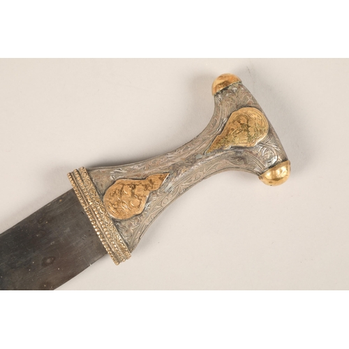 273 - A middle Eastern Omani white metal mounted Jambiya dagger, with gilt enrichments and engraved decora... 