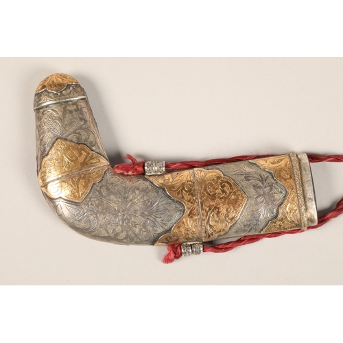 273 - A middle Eastern Omani white metal mounted Jambiya dagger, with gilt enrichments and engraved decora... 