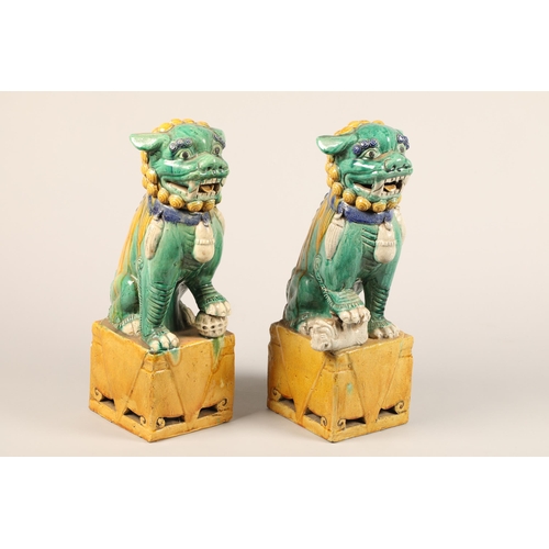 274 - Pair of large Chinese pottery figures of Buddha dogs, raised on square plinths, decorated with green... 