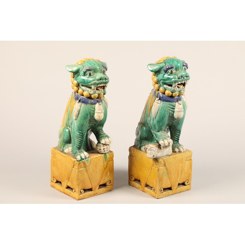 274 - Pair of large Chinese pottery figures of Buddha dogs, raised on square plinths, decorated with green... 