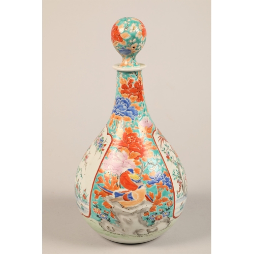 275 - Oriental ceramic bottle shaped decanter and stopper decorated with colourful peonies and birds with ... 