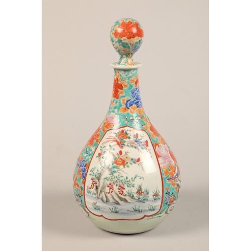 275 - Oriental ceramic bottle shaped decanter and stopper decorated with colourful peonies and birds with ... 