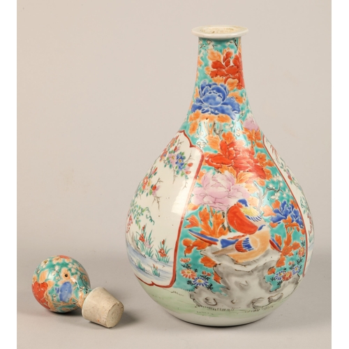 275 - Oriental ceramic bottle shaped decanter and stopper decorated with colourful peonies and birds with ... 