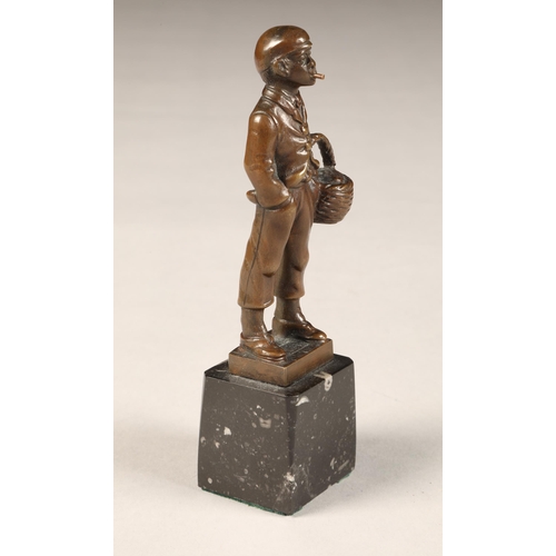 289 - EB Morty (German 20th century) bronze figure of a smoking boy with basket, height 16cm