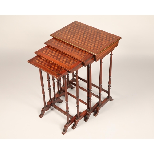 614 - Set of mahogany nest of quartet tables, the tops decorated with geometric parquetry, raised on slend... 