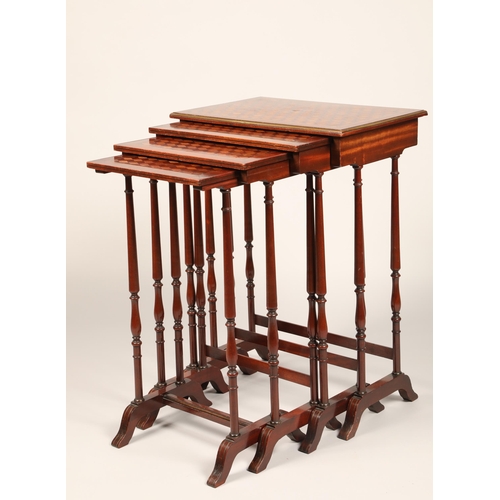 614 - Set of mahogany nest of quartet tables, the tops decorated with geometric parquetry, raised on slend... 