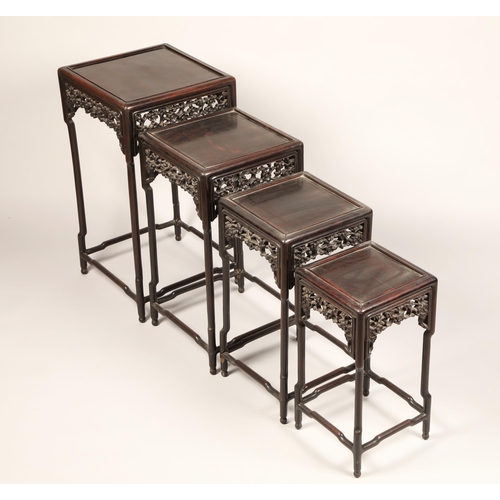 616 - Nest of four Chinese hardwood tables, rectangular painted tops with raised moulded edges above a fri... 